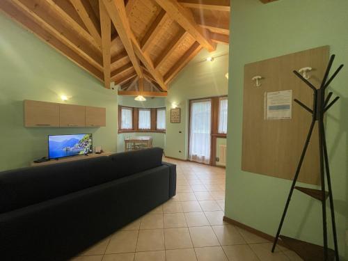 a living room with a couch and a tv at Residence Valentino in Pinzolo