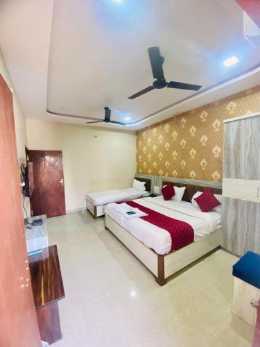 a bedroom with two beds and a ceiling at Hotel vinayak in Indore