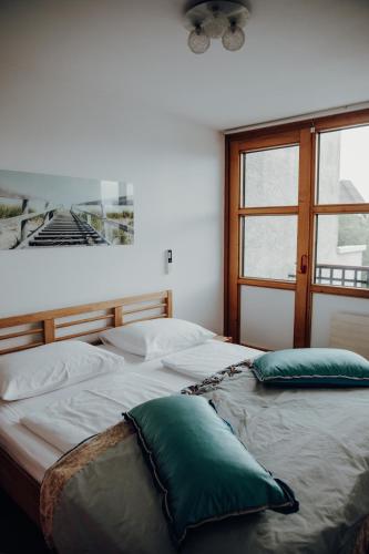 a bedroom with a bed with two pillows on it at Parkhotel Brunauer in Salzburg