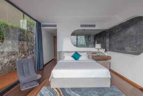 a bedroom with a large bed and a chair at Ocean Beach Villa Nha Trang in Nha Trang