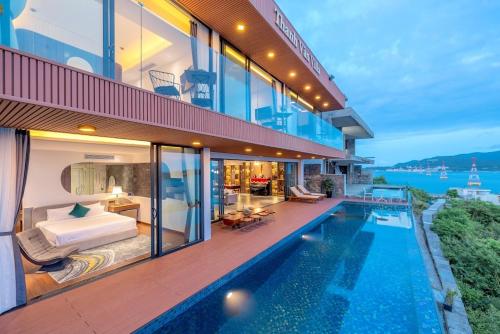 a house with a bedroom and a swimming pool at Ocean Beach Villa Nha Trang in Nha Trang