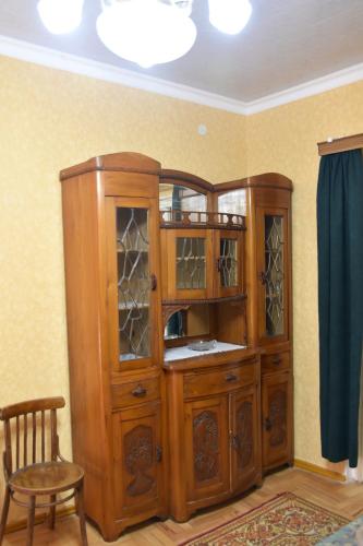 a wooden cabinet with glass doors in a room at Nadia & Minadora Central Retreat in Tʼelavi