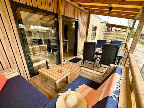 a screened in porch with two chairs and a table at Estivo Premium Deluxe mobile homes on Camping Del Sole Village in Iseo
