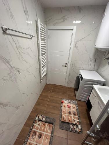 a bathroom with a toilet and a sink and a door at Apartman ARISTEA in Arandjelovac