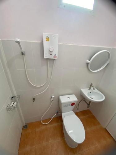 a bathroom with a toilet and a sink at โรงแรมบ้านสวนวินเทจ in Ban Nam Mong