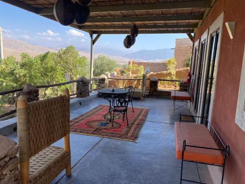 a balcony with a table and chairs and a view at Quelque part au barrage in Marrakech