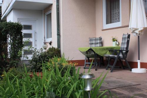 a patio with a table and chairs and an umbrella at Haus Müller Adelheid in Hilders
