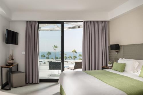 a bedroom with a bed and a view of the ocean at La Isla y el Mar, Hotel Boutique in Puerto del Carmen