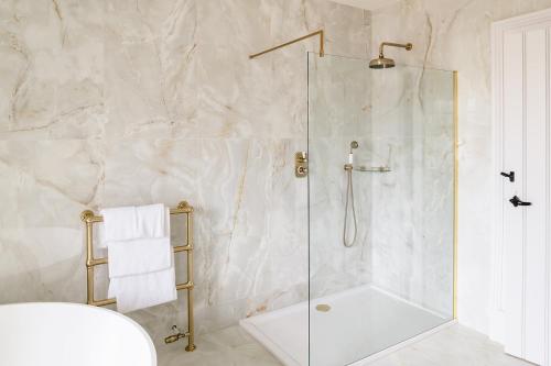 a shower with a glass door in a bathroom at Brig o' Doon House Hotel in Ayr