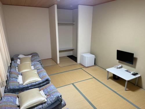 a living room with a couch and a table at GATE80長居 in Osaka