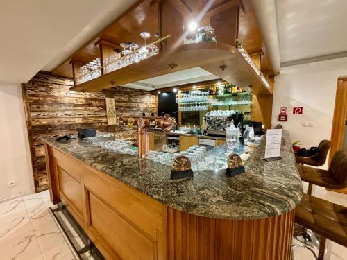 a kitchen with a bar in a restaurant at Hotel Raj in Dedinky