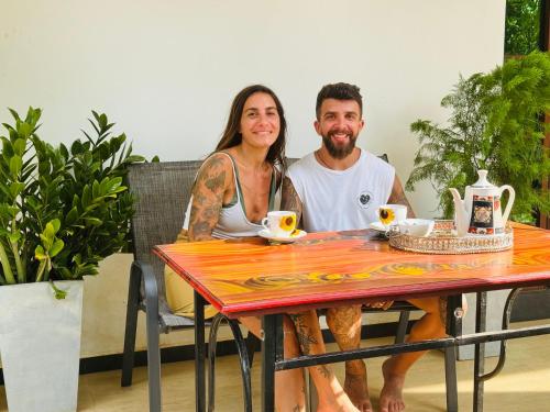 a man and a woman sitting at a table at Sri Ratnadeepa villa in Tissamaharama