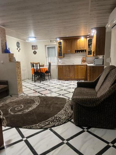 a living room with two chairs and a kitchen at Hotel Окремий Будинок-Апартаменти in Rakoshyno