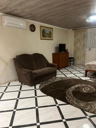 a living room with a couch and a table at Hotel Окремий Будинок-Апартаменти in Rakoshyno