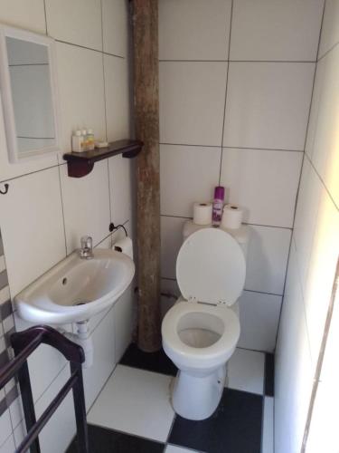a small bathroom with a toilet and a sink at Bushman Valley in Prince Albert