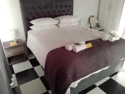 a bedroom with a bed with two towels on it at Bushman Valley in Prince Albert