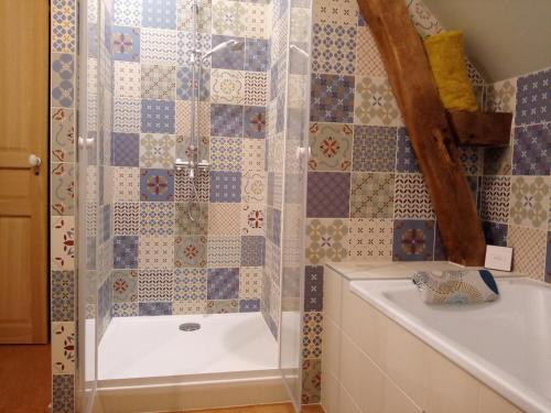 a bathroom with a shower and a tub and a sink at à la Mainguère, chambres d'hôtes in Brécé