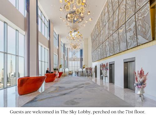 a lobby of a building with a chandelier at SLS Dubai Hotel & Residences in Dubai