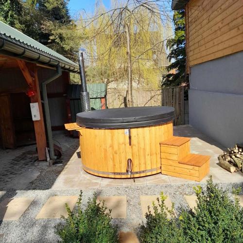 a wooden tub sitting outside of a house at Hacjenda - domek całoroczny in Krasnobród