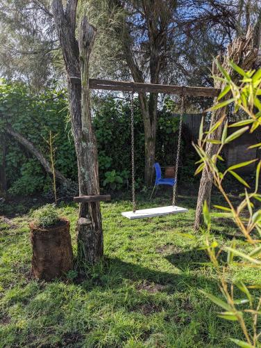 a swing in a yard with a tree at Kiamboni in Nakuru