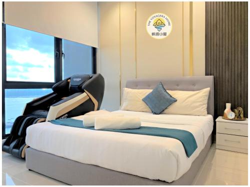 a bedroom with a large bed with a chair on it at Sea Park LeSu 8 The Shore KK I 1 plus 1 Room 2-3 Pax 홈스테이 A1710 in Kota Kinabalu