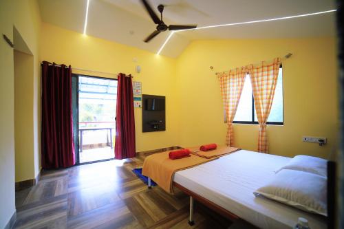 a bedroom with a bed with red pillows on it at Kamal Homes in Kīhīm