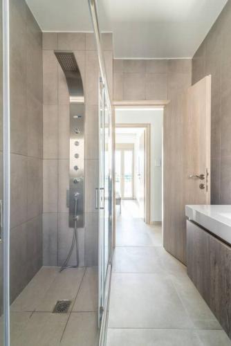 a bathroom with a shower and a phone in it at Modern Private Villa with Infinity Pool in Heraklion