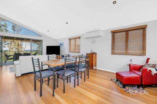 a dining room and living room with a table and chairs at 3-Bed Seaside Serenity Escape at Long Beach in Long Beach