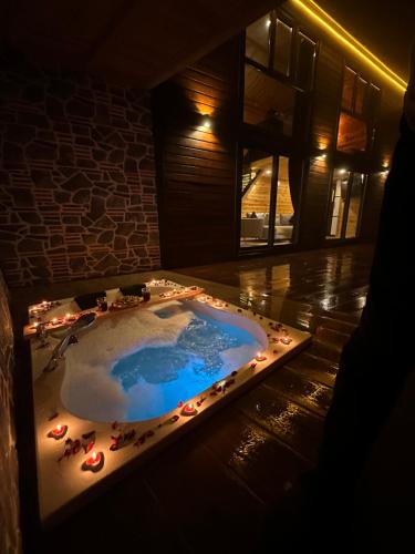 a jacuzzi tub with lights in a room at SEYRİ VADİ suit BUNGALOV in Ardeşen