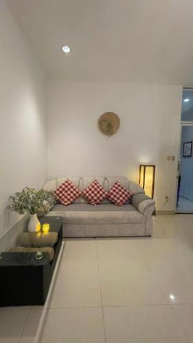 a living room with a couch with pillows on it at Rocky Cafe & Mini Apartment in Siem Reap