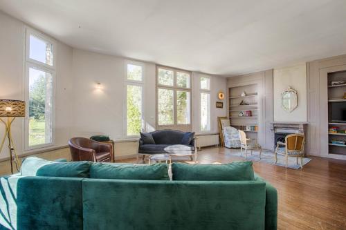 sala de estar con sofá verde y sillas en La Villa Océane — Beach & old presbytery en Lion-sur-Mer