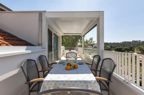 a table on the balcony of a house at Penthouse Nikolina-50m to beach! - Makarska Exklusiv in Makarska