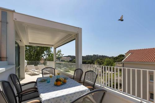 a patio with a table and chairs on a balcony at Penthouse Nikolina-50m to beach! - Makarska Exklusiv in Makarska