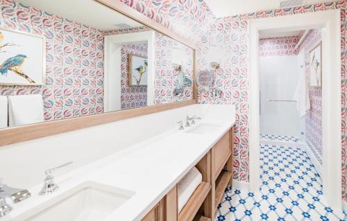 a bathroom with a white sink and a shower at The Inn at Stonecliffe in Mackinac Island