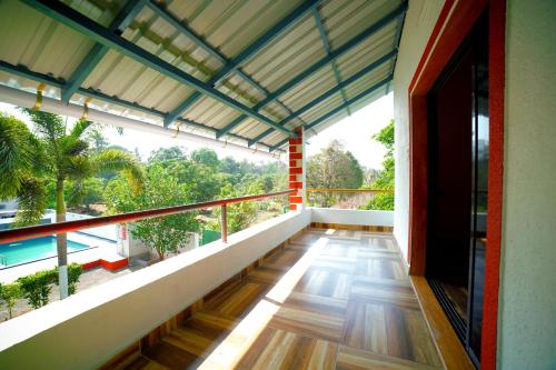 a balcony of a house with a view of trees at Kamal Homes in Kīhīm