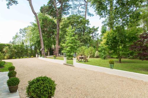 a walkway in a park with a picnic table at Maison Cuevas in Biarritz