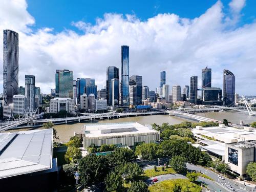 a view of a city with a river and buildings at Riverview Haven Prime Spot for NY Fireworks in Brisbane