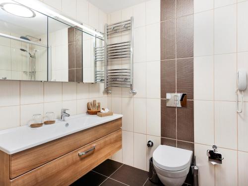 a bathroom with a toilet and a sink and a mirror at Nidya Hotel Esenyurt in Istanbul