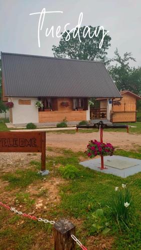 a log cabin with a sign in front of it at Kuća za odmor Antonija in Gospić