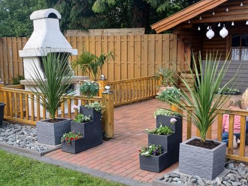 a garden with a fountain and potted plants at Haus Angelika in Berumbur