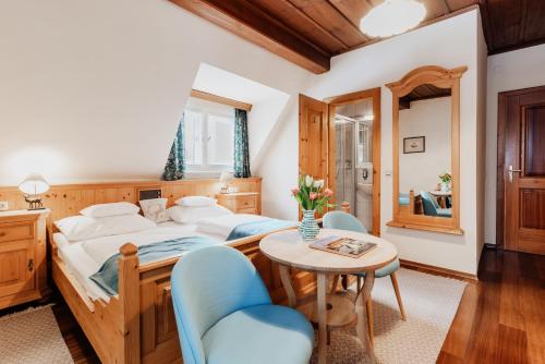 a bedroom with a bed and a table and chairs at Landhaus Koller in Gosau