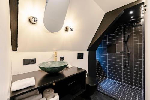 a bathroom with a sink and a shower at SUPPER Hotel in Amsterdam