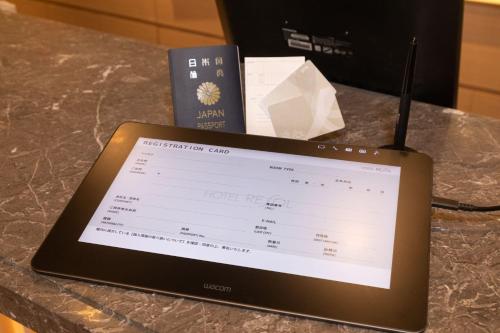 a tablet computer sitting on top of a counter at Hotel Resol Trinity Sapporo in Sapporo