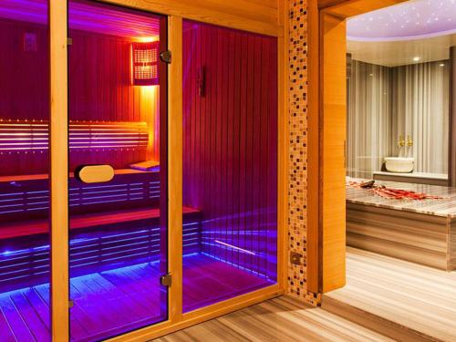 a room with purple lights in a room with a bedroom at Nidya Hotel Esenyurt in Istanbul