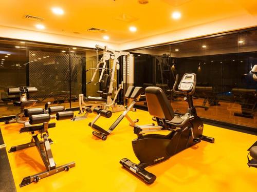 a gym with several exercise bikes on a yellow floor at Nidya Hotel Esenyurt in Istanbul