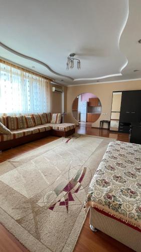 un ampio soggiorno con un divano e un tappeto di ЖК «Нурсая» a Astana
