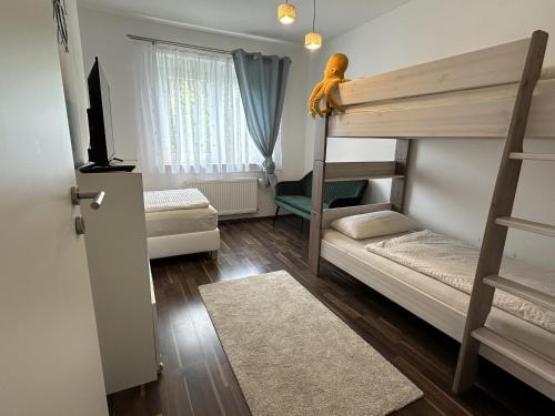 a small room with a bunk bed and a room with a couch at Dreams im Obergeschoss in Koetz 