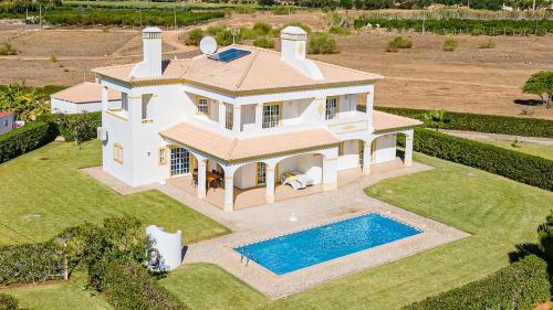 an aerial view of a house with a swimming pool at Filomena Golf Paradise in Guia