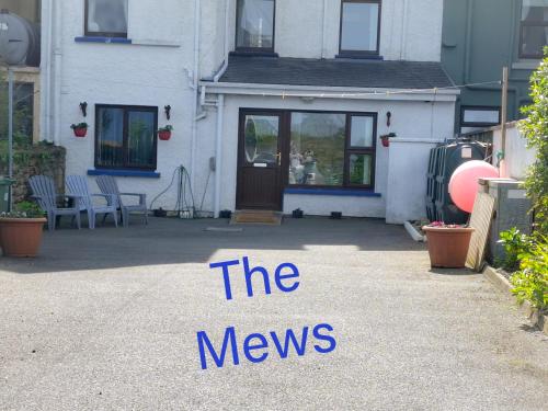 a house with a sign that reads the news at Mews Apartment Main St, Carrigart, F92HC04 in Carrigart