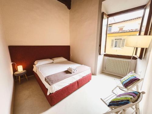 a small bedroom with a bed and a window at Luxury apartment SS Annunziata in Florence